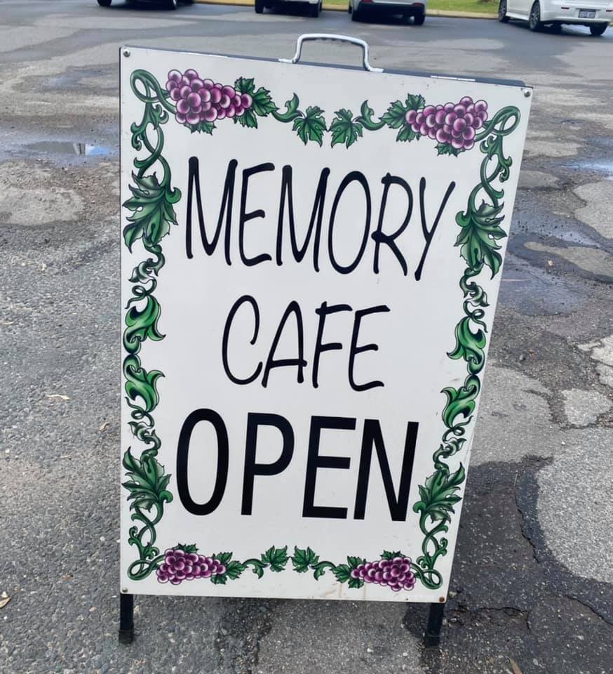 A sign saying memory cafe open